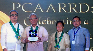 Dr. Stanley C. Malab (second from left) receives a plaque of recognition from PCAARRD for his outstanding leadership of ILARRDEC, one of the 14 regional consortia established by PCAARRD all over the country. Awarding him were Department of Science and Technology Secretary Mario G. Montejo (first from left), PCAARRD Executive Director Patricio S. Faylon (second from right), and PCAARRD Deputy Executive Director for  Administration, Resource Management and Support Services Danilo C. Cardenas. (Photo by Victor V. Oro, S&T Media Service)